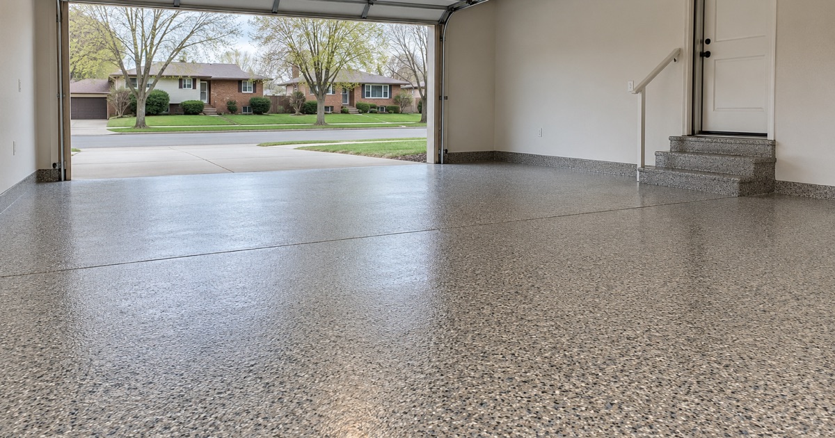 An empty finished flake garage floor in Arlington Heights, handed back with the door raised.